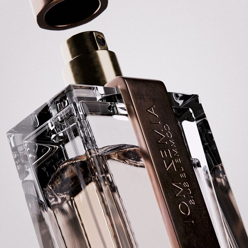 Luxurious perfume bottle with metallic cap and transparent glass display, ideal for high-end fragrance branding.