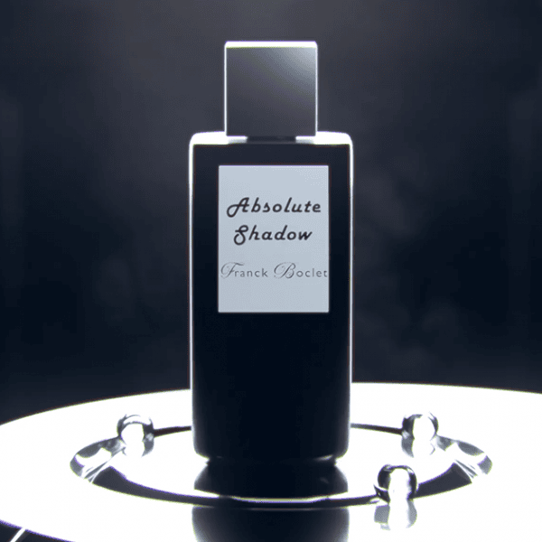 Luxury fragrance display with sleek black bottle and modern design elements.