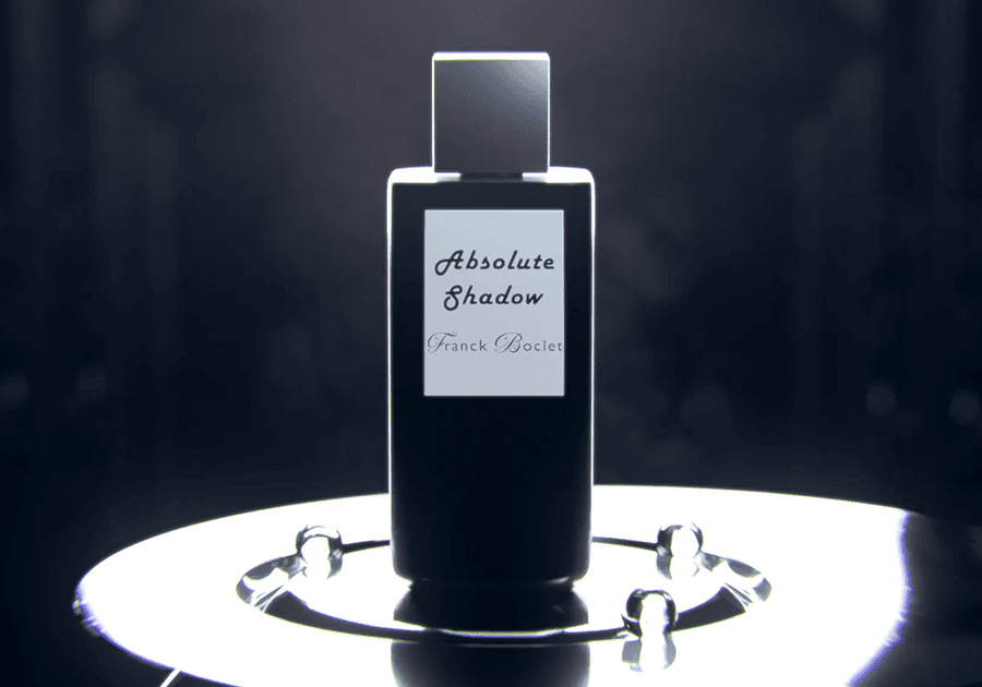 Luxury fragrance display with sleek black bottle and modern design elements.