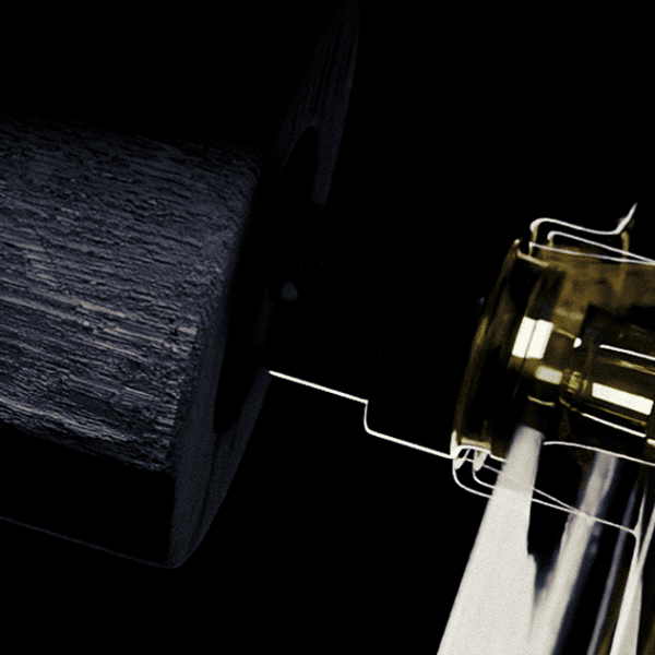 Close-up of a glass ring on sleek metallic jewelry display.